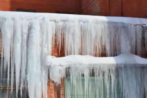 Frozen roof and ice dam water damage restoration service in Round Lake for winter storm property cleanup
