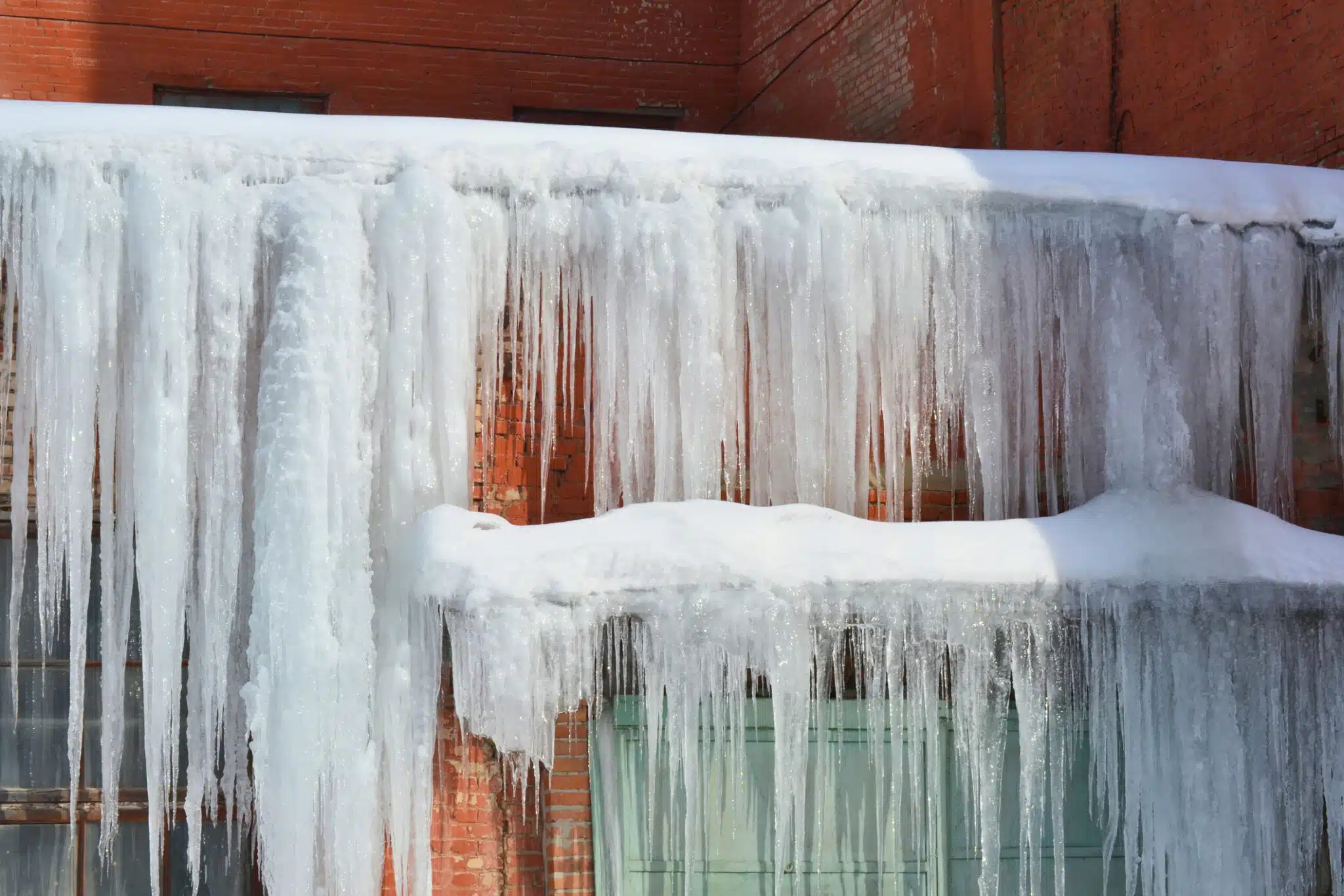 Frozen roof and ice dam water damage restoration service in Round Lake for winter storm property cleanup